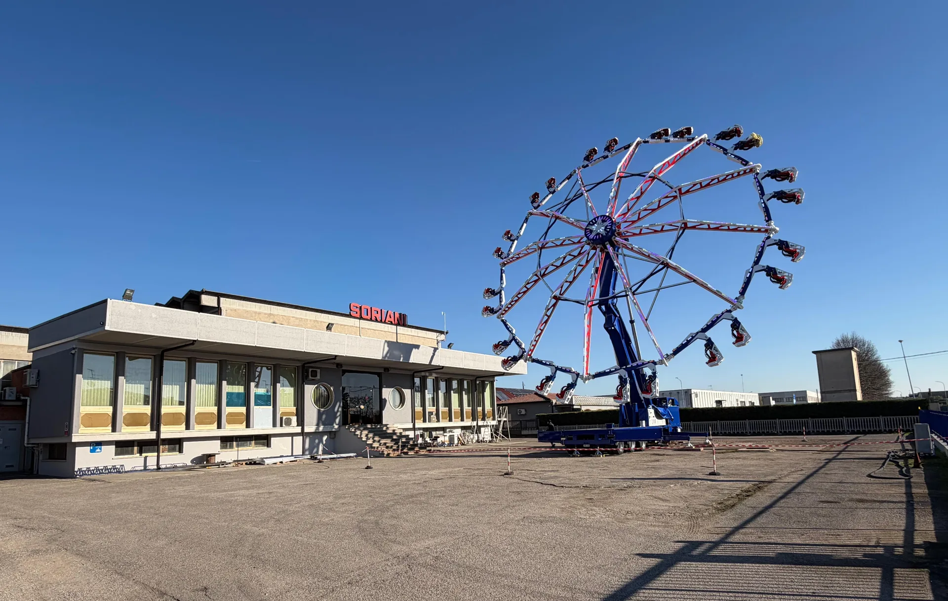 Soriani headquarters with an amusement ride assembled in the outdoor testing area